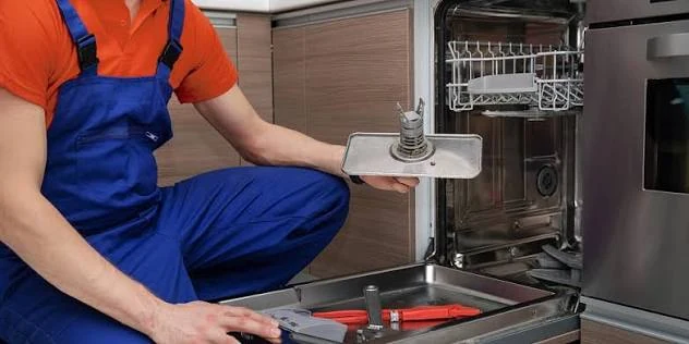 Technician inspecting a dishwasher filter and interior components