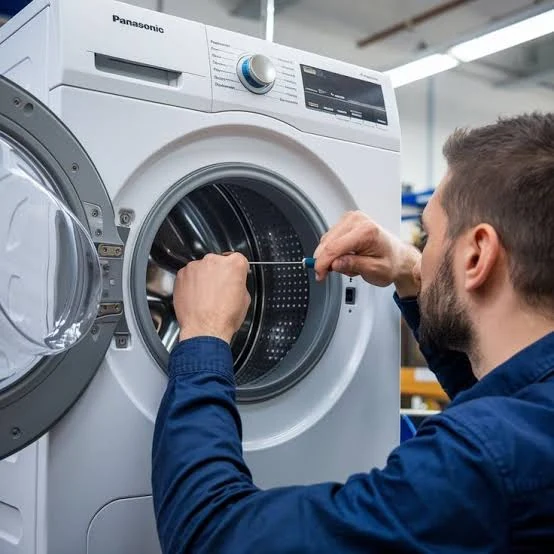 Technician working on the drum and door of a front-loading washing machine